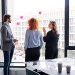 A group of young business people in an office, brainstorming