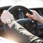 Cropped image of business man driving car