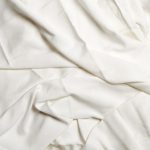 Textured white crumpled sheets