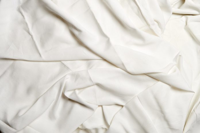 Textured white crumpled sheets